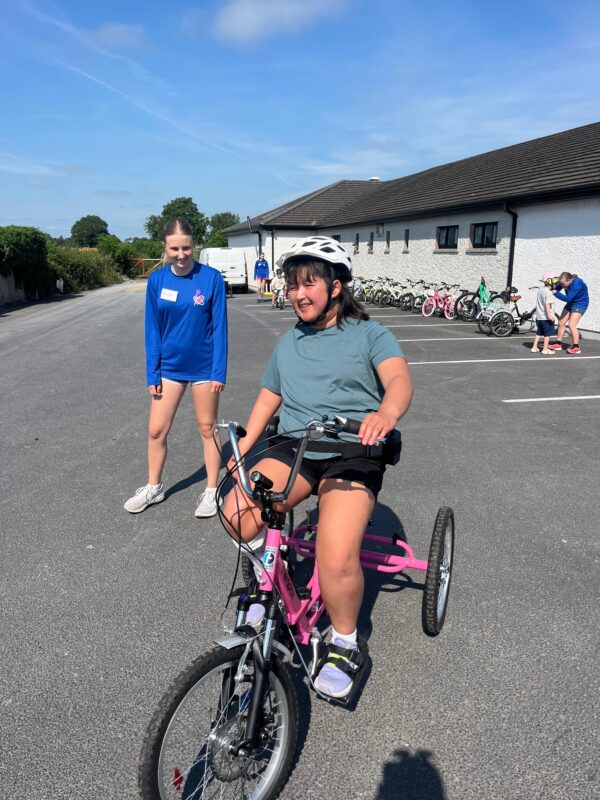 Child cycling on adapted bicycle