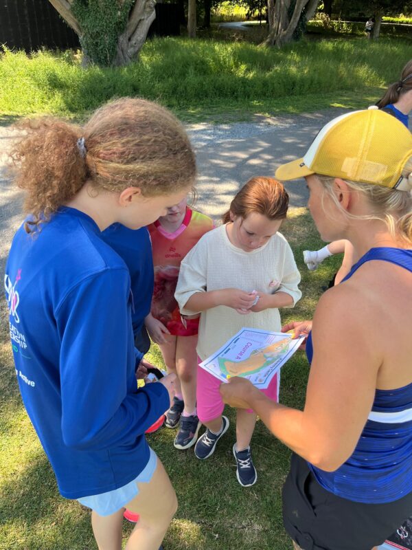 Children and youth volunteer looking at map.